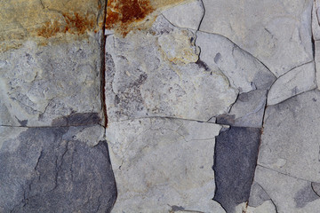 Grey dark stone surface texture with cracks. Sea limestone.