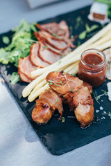 A restaurant serving Italian salad on a black square plate