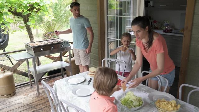 Family on vacation preparing outdoor lunch