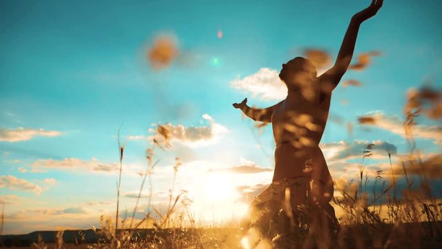 woman praying on her knees. Girl folded her hands in prayer silhouette at sunset. slow motion video. Girl folded her hands in prayer pray to God. the girl praying asks forgiveness lifestyle for sins