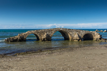 Seascape with medieval bridge in the water at Argassi beach, Zakynthos island, Greece