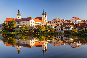 View of Telc across pond with reflections, southern Moravia, Czech Republic.