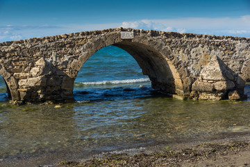 Fototapeta na wymiar Seascape with medieval bridge in the water at Argassi beach, Zakynthos island, Greece