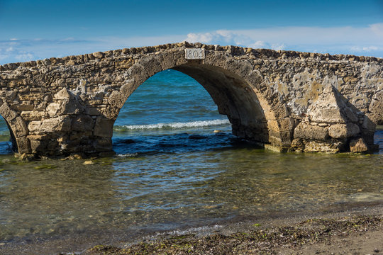 Seascape with medieval bridge in the water at Argassi beach, Zakynthos island, Greece