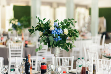 Banquet table is decorated with compositions of hydrangea flowers and greenery