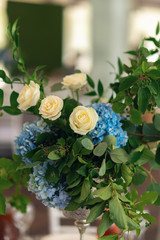 Banquet table is decorated with compositions of hydrangea flowers and greenery