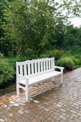 Lounge area for guests outside. Wedding decor. White bench in the park