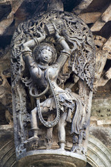 Shilabalika, celestial maiden, as a Dolu Kunita. A lady is palying a drum and dancing . Chennakeshava temple, Belur, Karnataka. Notice the hairstyle.