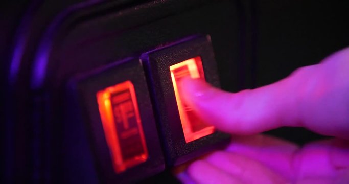 Close up fingers press red insert coin button on arcade video game for money back