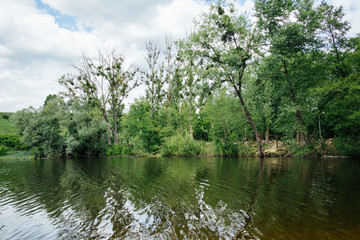 Amazing landscape of lake with clear green water and perfect blue sky. Nature and environment, ecology concept. Free clean climat. Non Water pollution