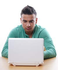 young man using laptop computer, isolated on white