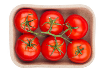Tray with fresh raw organic tomatoes on white