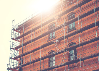 construction site at brick building with lens flare on the top