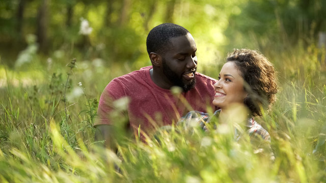 Beautiful couple spending time together at outdoor date, man making woman laugh - Powered by Adobe