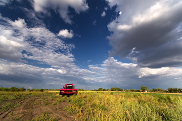 Fototapeta premium Red combine harvester in the field