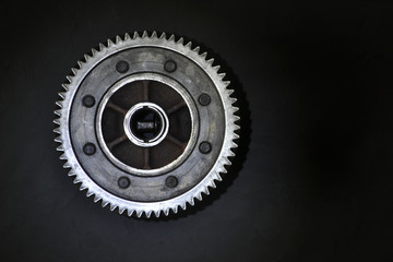 Gear on a black background. Free space for text.