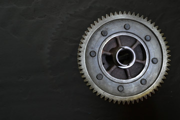 Obraz premium Gear on a black background. Free space for text.