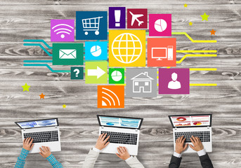 Top view of businesspeople sitting at table and using gadgets