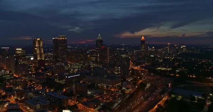 Atlanta Aerial v460 Flying backwards panning around downtown cityscape and freeway view at dusk 7/18