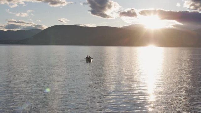 Slow Motion Two People in a Canoe on the Lake at Sunset