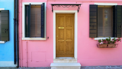 Fototapeta na wymiar Awesome cozy pink house on Burano island, doll-like building in Venice, travel
