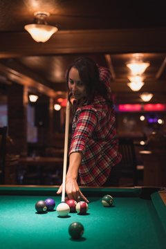 Woman playing snookers in the club