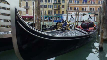 Fototapeta na wymiar Luxury gondola boats attracting tourists for romantic sightseeing tour in Venice