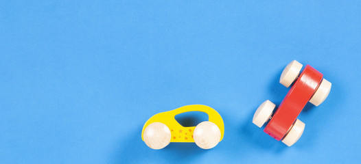 Two Wooden Toy Cars on Blue Background