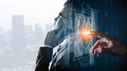 The double exposure image of the businessman using a smartphone overlay with cityscape and futuristic hologram image. The concept of modern life, business, city life and internet of things.
