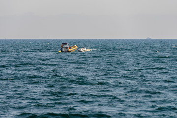 seascape with a motor boat on the horizon