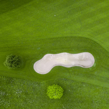 Germany, Baden-Wuerttemberg, Aerial view of golf course with bunker, green and hole