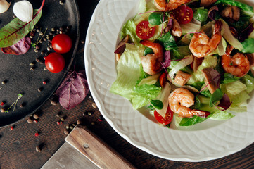 vegetable salad with shrimps composition dark wood background