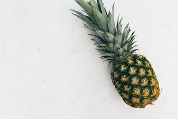 Pineapple fruit on white marble background