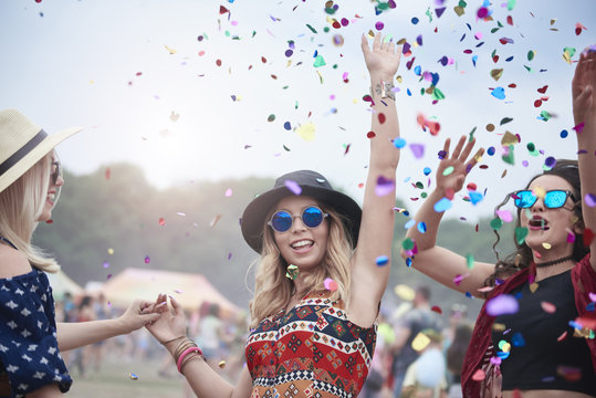 Three young women dancing at festival