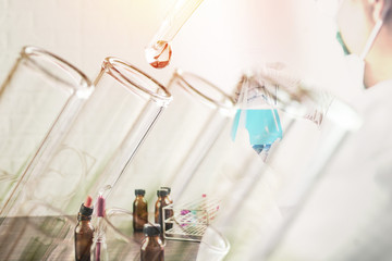 Close up  medical glassware with chemical drop, Man Research Scientist  holding test tube and working in laboratory.