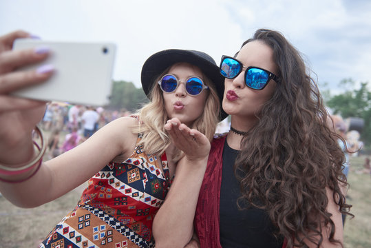 Two young women taking selfie at festival