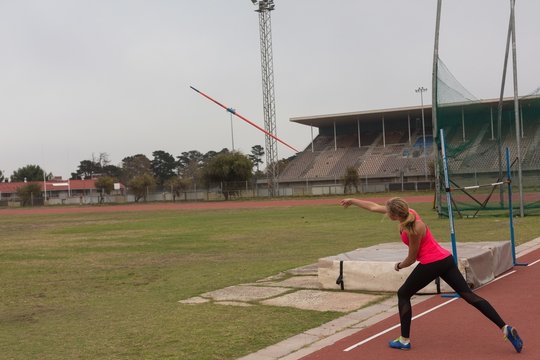 Female athlete practicing javelin throw - Powered by Adobe