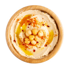 Classic chickpea hummus with olive oil and paprika in wooden bowl isolated on white.