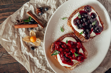sweet toast with berry jam at parchment background