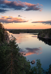 Fototapeta na wymiar Scenic high angle view with sunrise and peaceful lake at summer evening in Finland