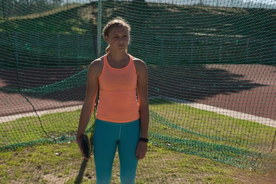 Female athlete practicing discus throw