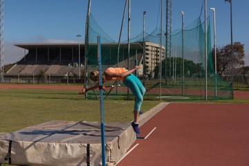 Female athlete practicing high jump
