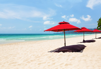 Beach chairs with umbrella and beautiful sand beach