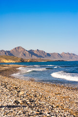 Fototapeta na wymiar View of the Mediterranean Sea with shingle beach an waves.