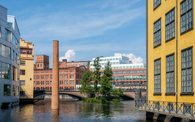Motala river and the industrial landscape during summer in Norrkoping. Norrkoping is a historic industrial town in Sweden.