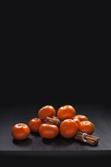 Mandarins and Cinnamon on Black Background Christmas New Year Halloween