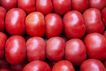 Heap of fresh ripe red tomatoes without branches close up.
