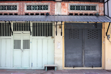 vintage chino-protugese architecture style building with wooden folding door