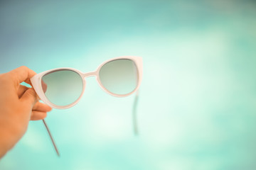 Cool sunglasses in woman hand