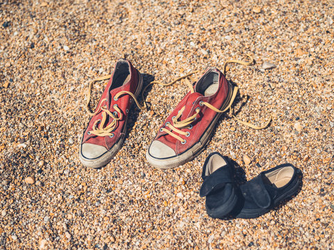 Adult and children shoes on beach